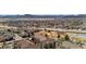 Scenic aerial view of a neighborhood with lush trees, pool, mountains, and multi-Gathering housing at 8422 S Upham Way # G47, Littleton, CO 80128