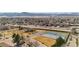 Scenic community aerial view highlighting a tennis court, ample parking, and proximity to surrounding landscapes at 8422 S Upham Way # G47, Littleton, CO 80128