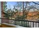 View from balcony, overlooking the surrounding trees, neighborhood, and road with black metal safety rail at 8422 S Upham Way # G47, Littleton, CO 80128