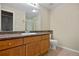 Single sink vanity with wood cabinets and framed mirror in the bathroom at 8422 S Upham Way # G47, Littleton, CO 80128