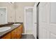 Bathroom with a double vanity sink, wood cabinets, and a shower-tub combo at 8422 S Upham Way # G47, Littleton, CO 80128