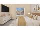 Bright bedroom with a large window, comfortable bed, and modern dresser at 8422 S Upham Way # G47, Littleton, CO 80128