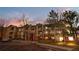 Exterior view of a multi-story apartment complex with brick and siding, landscaped grounds, and private parking at 8422 S Upham Way # G47, Littleton, CO 80128