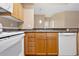 Bright kitchen showcasing light wood cabinets, laminate counters, white appliances, and undermount sink at 8422 S Upham Way # G47, Littleton, CO 80128