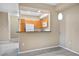 Partially open kitchen with wood cabinets, white appliances, and a view to the dining and living areas at 8422 S Upham Way # G47, Littleton, CO 80128