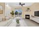 Bright living room with a fireplace, ceiling fan and sliding door to a balcony with seating at 8422 S Upham Way # G47, Littleton, CO 80128