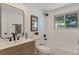 Bathroom with tub, toilet and updated vanity at 34 University Dr, Longmont, CO 80503