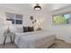 Bright bedroom with a queen-size bed and ample natural light at 34 University Dr, Longmont, CO 80503