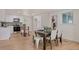 Kitchen and dining area with hardwood floors, white cabinets, and modern table at 34 University Dr, Longmont, CO 80503