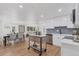 Modern kitchen with white cabinets, stainless steel appliances, and herringbone backsplash at 34 University Dr, Longmont, CO 80503