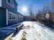 Snowy backyard with wooden fence and landscaping at 245 Dunhill St, Castle Rock, CO 80104