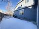 Side yard view with snow and wooden fence at 245 Dunhill St, Castle Rock, CO 80104