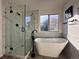 Modern bathroom featuring a soaking tub and a glass-enclosed shower at 245 Dunhill St, Castle Rock, CO 80104