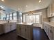 Modern kitchen with gray cabinets, quartz countertops, and island at 245 Dunhill St, Castle Rock, CO 80104