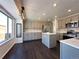 Modern kitchen with gray cabinets, quartz countertops, and island at 245 Dunhill St, Castle Rock, CO 80104