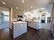 Modern kitchen with gray cabinets, quartz countertops, and island at 245 Dunhill St, Castle Rock, CO 80104