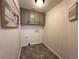 Laundry room with upper cabinets and tile floor at 245 Dunhill St, Castle Rock, CO 80104