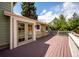 Backyard deck featuring access to the home's French doors and lush landscaping all around at 7863 W Quarto Ave, Littleton, CO 80128