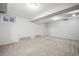 Spacious basement with neutral carpet, bright lighting, and multiple windows for natural light at 7863 W Quarto Ave, Littleton, CO 80128