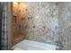 Close up of bathroom featuring beige tile and a built in bench in the shower/tub at 7863 W Quarto Ave, Littleton, CO 80128