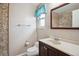 Cozy bathroom featuring a mosaic tile shower and charming window with a blue valance at 7863 W Quarto Ave, Littleton, CO 80128