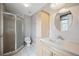 Bathroom with stand-up shower, cream vanity, and tile flooring at 7863 W Quarto Ave, Littleton, CO 80128