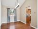Elegant dining room with hardwood floors, modern lighting, and access to the kitchen, great for gatherings at 7863 W Quarto Ave, Littleton, CO 80128