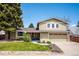 Charming two-story home with an attached garage and a well-manicured front lawn, perfect for Gathering living at 7863 W Quarto Ave, Littleton, CO 80128