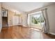 Bright living room featuring hardwood floors, neutral walls, and a staircase leading to the upper level at 7863 W Quarto Ave, Littleton, CO 80128