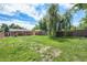 Expansive backyard featuring a lush green lawn, mature trees, and a charming patio area at 457 S Locust St, Denver, CO 80224