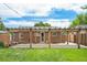 A backyard features a wooden pergola covering a brick patio, enhancing the outdoor space for relaxation and entertaining at 457 S Locust St, Denver, CO 80224