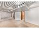 Spacious basement with carpet, white ceiling, and a door leading to another room at 457 S Locust St, Denver, CO 80224