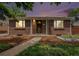Charming brick home featuring a well-maintained front yard and a welcoming entryway with a beautiful dusk sky at 457 S Locust St, Denver, CO 80224