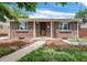 Charming brick home featuring a well-maintained front yard and a welcoming entryway under blue skies at 457 S Locust St, Denver, CO 80224