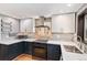Updated kitchen featuring sleek countertops, white cabinets, and modern stainless steel appliances at 457 S Locust St, Denver, CO 80224