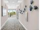 Bright hallway with large windows and unique wall art at 155 S Monaco Pkwy # 302, Denver, CO 80224