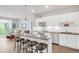 Modern kitchen with white cabinets, stainless steel appliances, and an island at 155 S Monaco Pkwy # 302, Denver, CO 80224