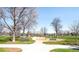 Park playground with playset, swings, and benches at 155 S Monaco Pkwy # 302, Denver, CO 80224