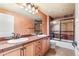 Bathroom with double sinks, tile floor, granite counters, and glass shower door at 27485 E Nova Pl, Aurora, CO 80016