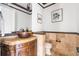 Powder room with decorative vanity, granite countertop and stone floors at 27485 E Nova Pl, Aurora, CO 80016