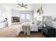 Bedroom showcasing a cozy fireplace, plush carpeting, and ample natural light from surrounding windows at 27485 E Nova Pl, Aurora, CO 80016