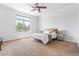 Bedroom featuring a large window with views of the yard, neutral walls and ceiling fan at 27485 E Nova Pl, Aurora, CO 80016