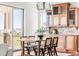 Dining area with glass cabinets, access to deck, and views at 27485 E Nova Pl, Aurora, CO 80016