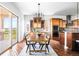 Dining area with glass cabinets, views, and access to the deck at 27485 E Nova Pl, Aurora, CO 80016
