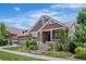 Beautiful home with a well-manicured front yard featuring stone steps and a covered porch at 27485 E Nova Pl, Aurora, CO 80016