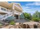 Beautiful home exterior featuring a stone facade, a covered balcony with white railings and rock landscaping at 27485 E Nova Pl, Aurora, CO 80016