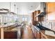 Spacious kitchen with a large island, granite countertops, and stainless steel appliances at 27485 E Nova Pl, Aurora, CO 80016