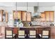 Gorgeous kitchen island has seating, granite countertops, pendant lights and designer tile backsplash at 27485 E Nova Pl, Aurora, CO 80016