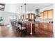 Open-concept kitchen features large island, stainless appliances, and breakfast area with access to patio at 27485 E Nova Pl, Aurora, CO 80016