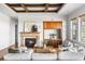 Inviting living room boasts coffered ceilings, stone fireplace, built-in cabinets and serene natural light at 27485 E Nova Pl, Aurora, CO 80016